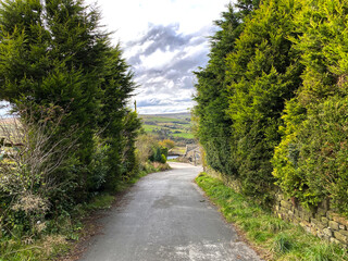 Looking down, Sawood Lane, with hills and valleys, in the distance near, Oxenhope, Keighley, UK