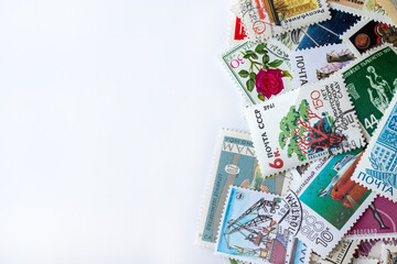 Multicolored postage stamps collection from different countries on white background