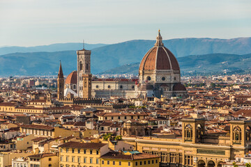 Fototapeta na wymiar Lovely view overlooking the historic city centre of Florence with the Duomo, Giotto's bell tower, the Bargello and the Badia Fiorentina. In the background are the hills of Settignano and Fiesole.