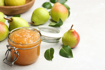 Delicious pear jam and fresh fruits on light grey table. Space for text