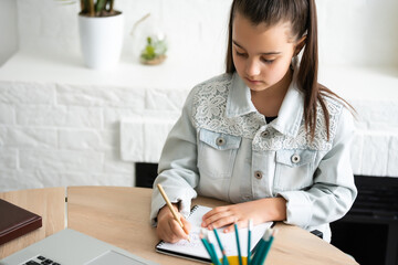 Student little school girl homework on laptop computer silver