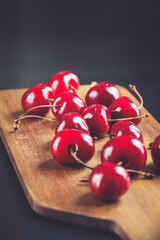 Fresh cherries on a wooden cutting board