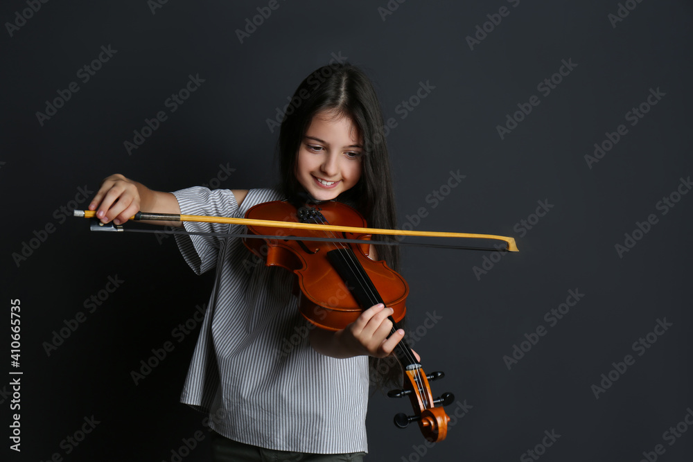 Sticker Preteen girl playing violin on black background