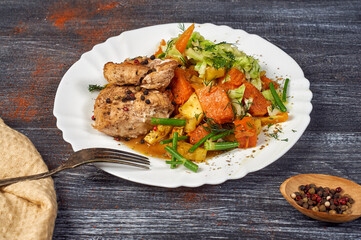 chicken breast with vegetables in a plate on the table