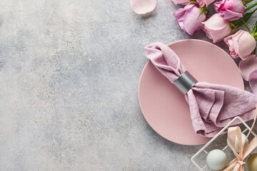 Easter table setting with floral decor on grey table. Elegance dinner. Mock up. Top view.