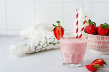 Vegetarian healthy smoothie from strawberry with berries on gray or white concrete background. Selective focus. Space for text.