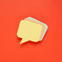 Multicolor speech bubbles on red background.