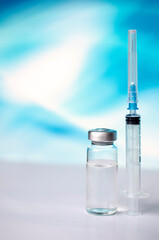 Ampoules and syringe with Covid-19 vaccine on a laboratory table.For the prevention, immunization and treatment of coronavirus infection.Infectious medicine concept. With copy space