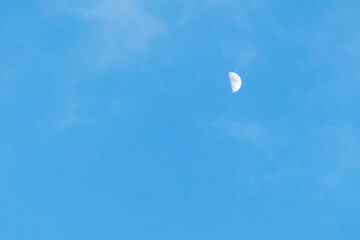 moon in a beautiful, blue sky in the early evening in good weather