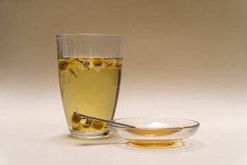 Beautiful chamomile flower tea in a glass and honey