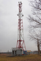 Tower with telecommunication antennas in rainy weather.