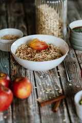 A porridge bowl with apples and cinnamon, food still life, healthy breakfast