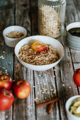 A porridge bowl with apples and cinnamon, food still life, healthy breakfast