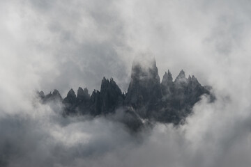 Close up of dark alpine peaks framed by stormy clouds
