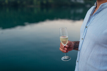 Male is drinking wine surrounded by beautiful nature
