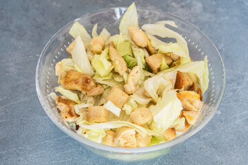 Caesar salad with toast, lettuce and grilled chicken breast