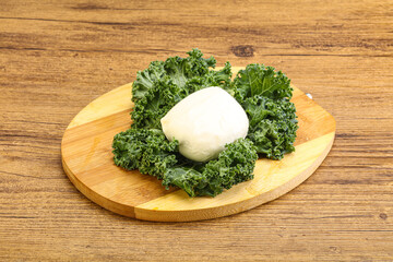 Soft mozzarella cheese over board