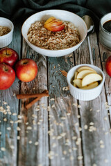A porridge bowl with apples and cinnamon, food still life, healthy breakfast