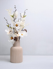 Tender bouquet of white flowers in ivory vase. Interior floral decoration. Valentines day gift idea.