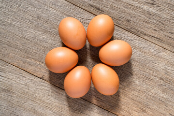 Chicken egg on the wooden board background. Flat lay.