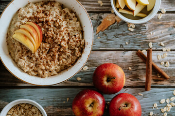A porridge bowl with apples and cinnamon, food still life, healthy breakfast