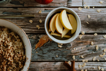 A porridge bowl with apples and cinnamon, food still life, healthy breakfast