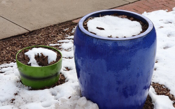 Snow In Colorful Planters In Winter