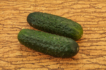 Green fresh cucumbers over background