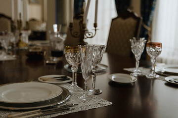 Served table for dinner. Table, candles, glasses. A restaurant. Dining room in the mansion.