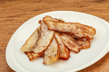 Roasted juicy bacon in the plate