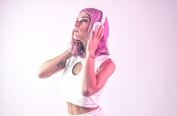 Young woman with pink hair dancing and having fun