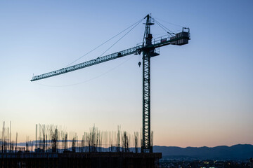 Fototapeta na wymiar large building construction crane in sunset cordoba argentina