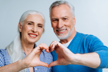 Happy senior couple posing in a studio for a photoshooting