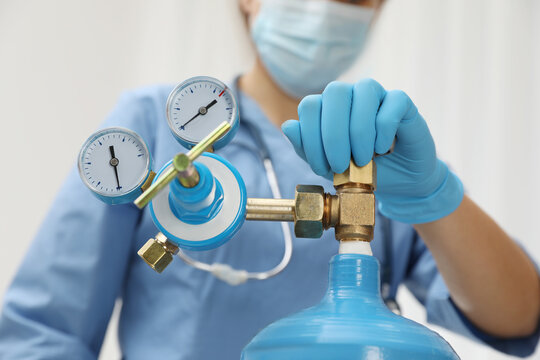 Medical Worker Checking Oxygen Tank In Hospital Room, Closeup