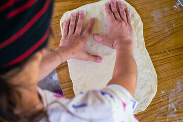 hand of person kneading flour with water and yeast for homemade bread cordoba argentina