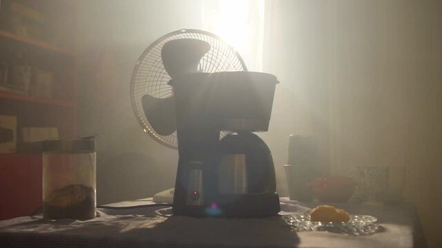 Fan running near a coffee maker