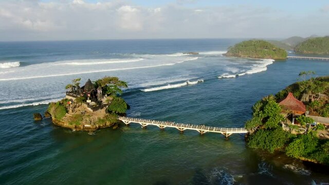 Picturesque Balekambang Hindu Temple on rocky island on Java coast, aerial view