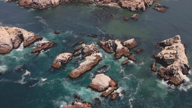 Drone shot from Arequipa coast, surounded by maritime rocks.