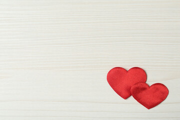 Decorative hearts on white wooden table, flat lay with space for text. Valentine's day