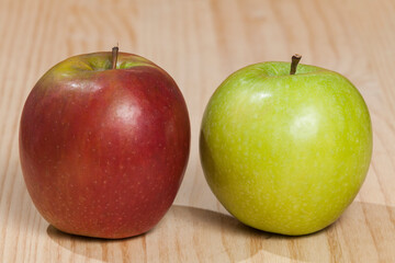 Red and green apple; photo on wooden background.