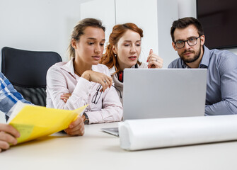 Group of designers and programmers starting a new project at the office.	
