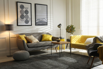 Stylish living room with sofas. Interior design in grey and yellow colors