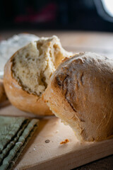 Hot homemade bread with moisture vapor freshly made in a Chilean clay oven with white flour and women's hands Cordoba Argentina