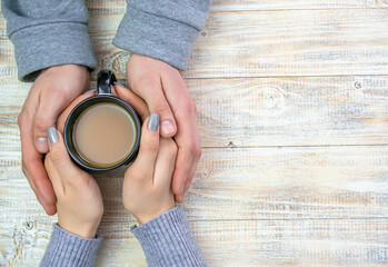 Concept of male and female hands, love and coffee