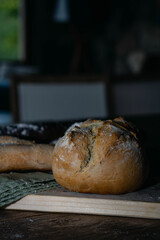 Hot homemade bread with moisture vapor freshly made in a Chilean clay oven with white flour and women's hands Cordoba Argentina