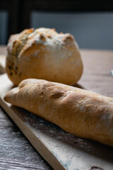 Hot homemade bread with moisture vapor freshly made in a Chilean clay oven with white flour and women's hands Cordoba Argentina