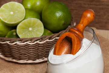 baking soda (sodium bicarbonate) and lemon; Photo on wooden background.