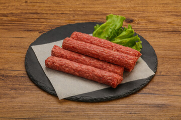 Raw beef sausages with spices