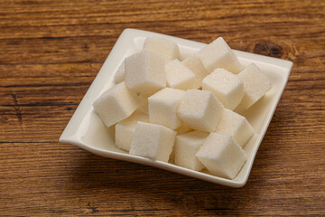 Refined white sugar cubs in the bowl