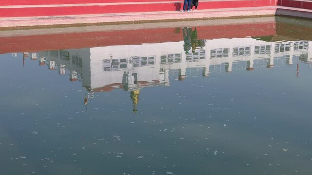 Holy Temple in Lumbini reflected in the holy pond. Birth place of Gautama Buddha. Maya Devi Temple.